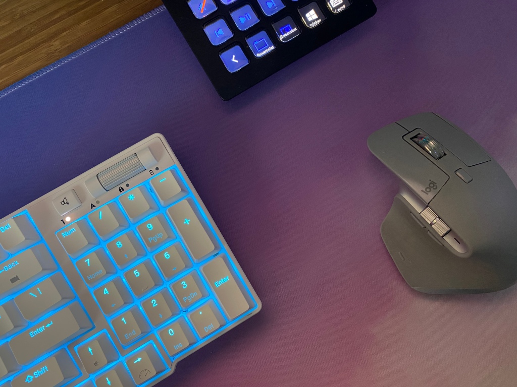 Royal Kludge RK96 mechanical keyboard next to a mouse on a desk.