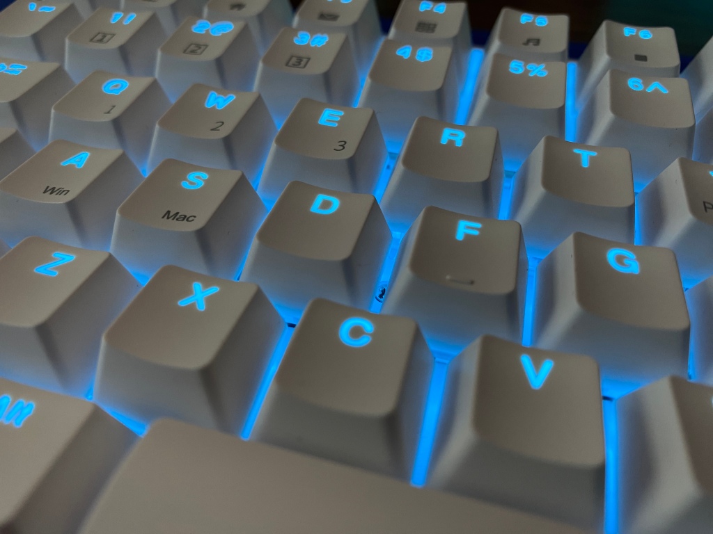 Close up of Royal Kludge RK96 mechanical keyboard with RGB lighting enabled. 